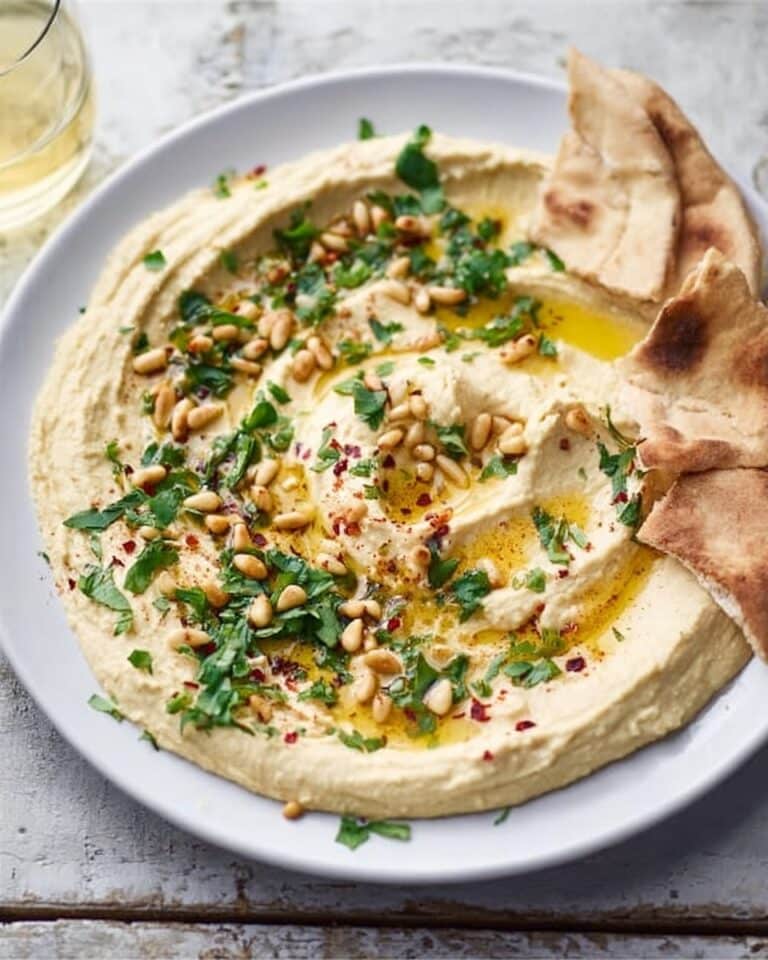 Lemony Spiced Hummus with Harissa, Pine Nuts, and Fresh Herbs Recipe