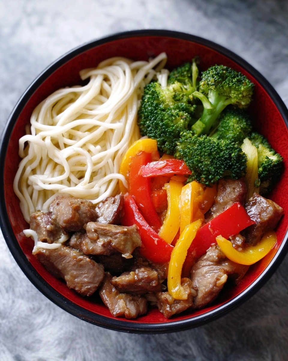 A white bowl filled with three main layers: on one side, thin white noodles arranged loosely; next to the noodles, pieces of cooked beef with a glossy brown sauce; mixed in and over the beef are bright green broccolini with small florets, chunks of yellow bell pepper, and slices of red bell pepper, adding vibrant colors and a fresh texture; the bowl sits on a white marbled surface. photo taken with an iphone --ar 4:5 --v 7