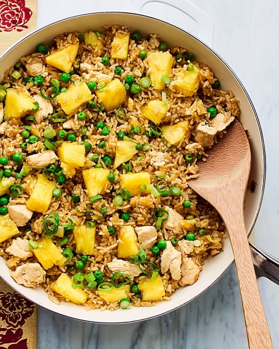 A white pan filled with fried rice that has three main layers: the base layer of brown fried rice grains spread evenly, mixed with bright green peas and chopped green onions scattered throughout; the middle layer of golden yellow pineapple chunks placed evenly on top of the rice; and the top layer of light brown, cooked chicken strips that are spread over the rice and pineapple. A wooden spoon is resting inside the pan, partially covered with the fried rice mixture. The pan sits on a beige cutting board which is placed on a white marbled surface. Photo taken with an iphone --ar 4:5 --v 7
