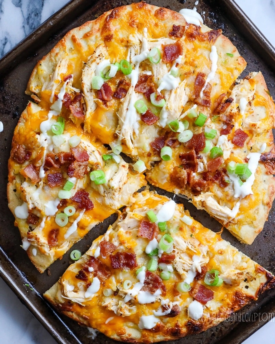 The image shows a small flatbread pizza cut into four slices placed on a metal baking tray. The pizza has a golden-brown crust with a layer of melted cheddar and mozzarella cheese covering the surface. On top, there are pieces of white shredded chicken, crispy bacon bits, and green chopped scallions scattered evenly. White ranch dressing is drizzled over the pizza, adding a creamy texture against the warm colors of the cheese and toppings. The background features a white marbled texture underneath the baking tray. Photo taken with an iphone --ar 4:5 --v 7