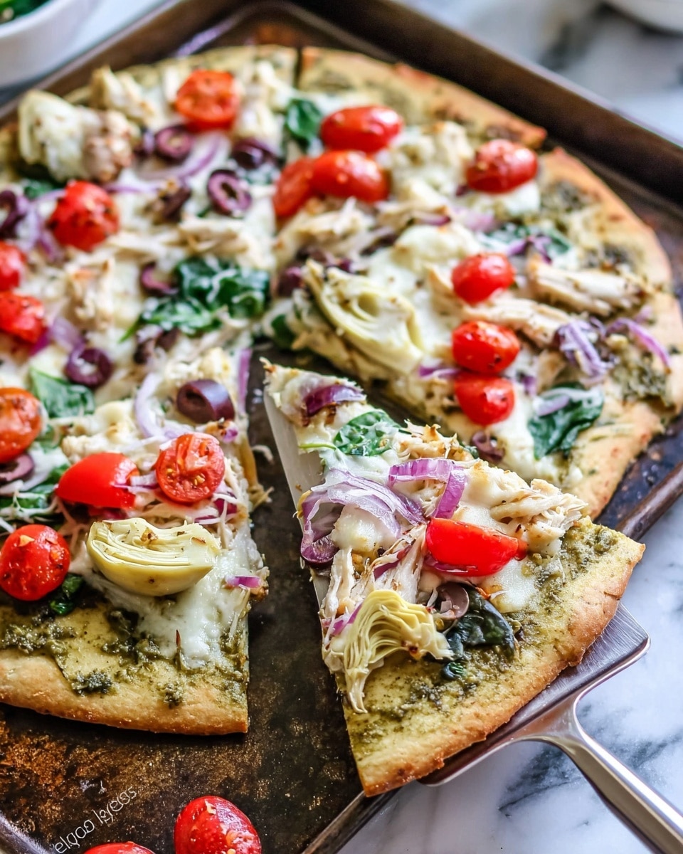 The image shows a thin, golden-brown pizza with a slightly crispy crust on a worn baking tray. The pizza is topped with several layers: a green pesto sauce base, melted white cheese scattered unevenly, chunks of white cheese dolloped on top, shredded white chicken pieces, fresh green spinach leaves, sliced black olives, thin slices of pale purple onion, halved bright red cherry tomatoes, and small white cauliflower florets. One slice is lifted on a metal spatula, showing the toppings clearly, and the whole scene rests on a white marbled surface. photo taken with an iphone --ar 4:5 --v 7