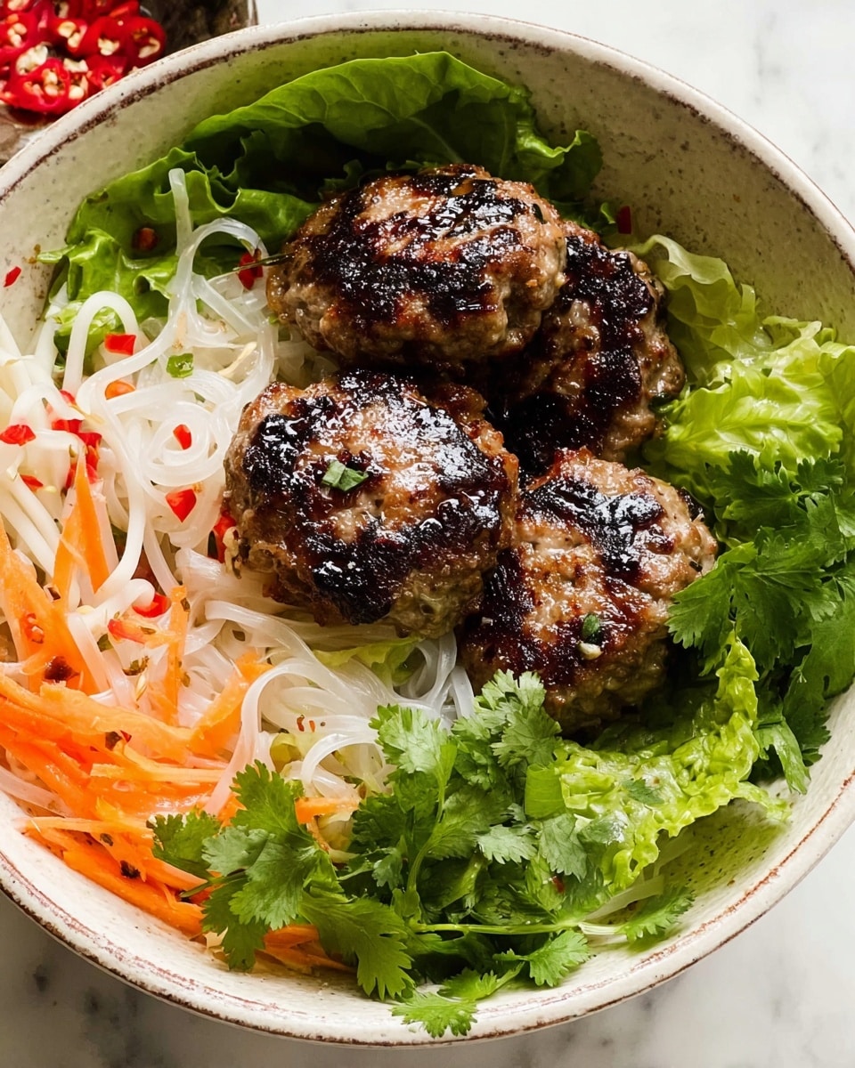 The dish is arranged in a white bowl with a slightly worn rim, resting on a white marbled surface. At the bottom layer, there are fresh green lettuce leaves forming a base. On top of the lettuce, there are thin white rice noodles with a delicate, soft texture, lightly tangled and spread. To the side and slightly overlapping the noodles, there are crunchy bean sprouts mixed with thin orange carrot strips. On top, three browned grilled meat patties with a slightly charred surface and a glistening, juicy texture are placed. Fresh green cilantro leaves are scattered throughout the dish, adding a touch of brightness. photo taken with an iphone --ar 4:5 --v 7